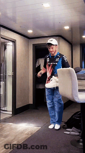 A Man Wearing A Alpine Shirt Stands In A Room GIF