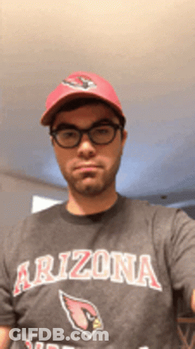 A Man Wearing A Arizona T-Shirt And A Red Hat Takes A Selfie GIF