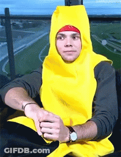 A Man Wearing A Banana Costume Is Sitting On A Chair GIF