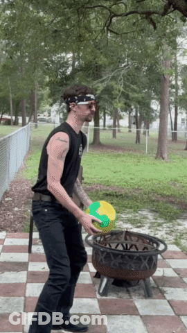 A Man Wearing A Bandana And Sunglasses Is Throwing A Ball In A Fire Pit GIF