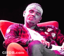 A Man Wearing A Bandana Is Sitting In A Chair GIF