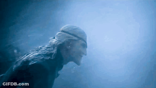 A Man Wearing A Bandana Is Swimming In The Water GIF