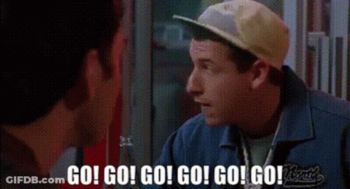 A Man Wearing A Baseball Cap And A Blue Shirt Is Talking To Another Man . GIF