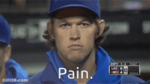A Man Wearing A Baseball Cap And A Blue Shirt Says Pain GIF