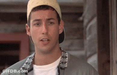 A Man Wearing A Baseball Cap And A Gray Shirt Is Making A Funny Face . GIF
