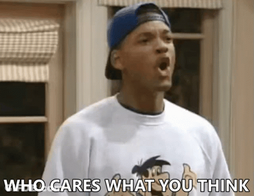 A Man Wearing A Baseball Cap And A T-Shirt With The Words Who Cares What You Think On It GIF