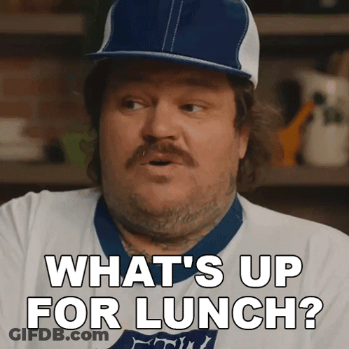 A Man Wearing A Baseball Cap And A White Shirt Says What 'S Up For Lunch GIF