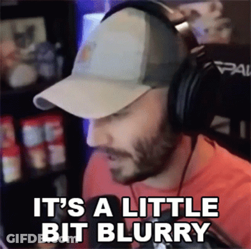 A Man Wearing A Baseball Cap And Headphones Says It 'S A Little Bit Blurry GIF