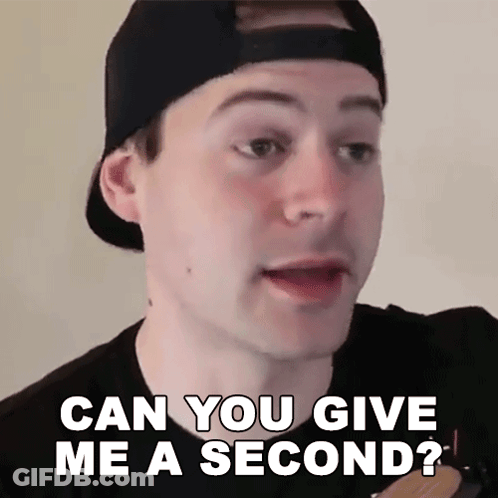 A Man Wearing A Baseball Cap Is Asking If He Can Give Me A Second GIF