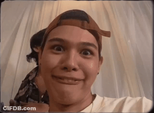 A Man Wearing A Baseball Cap Is Making A Face GIF