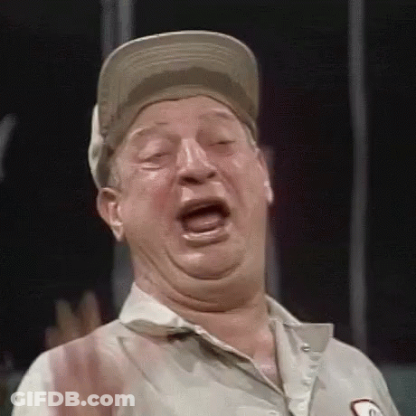 A Man Wearing A Baseball Cap Is Making A Funny Face . GIF