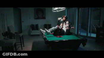 A Man Wearing A Baseball Cap Is Sitting On A Couch Holding A Stack Of Money . GIF