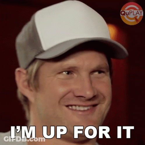 A Man Wearing A Baseball Cap Is Smiling And Says I 'M Up For It GIF