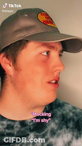 A Man Wearing A Bass Pro Shops Hat Says " Mocking " I 'M Shy " GIF