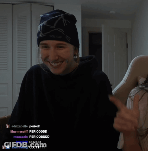 A Man Wearing A Beanie And A Black Hoodie Is Smiling In Front Of A Screen That Says Majorload08 GIF