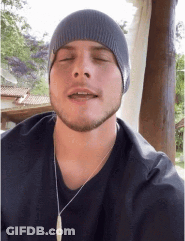 Man In Beanie And Necklace With Eyes Closed GIF