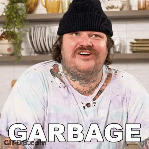 A Man Wearing A Beanie And A White T-Shirt With Garbage Written On It GIF