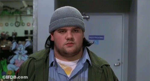 A Man Wearing A Beanie Is Standing In Front Of A Door That Says Destructions GIF