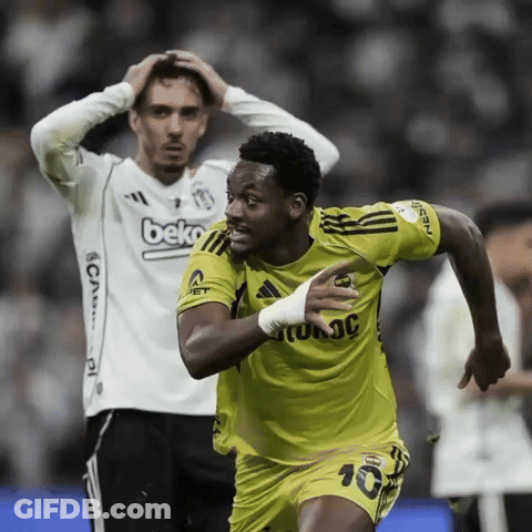 A Man Wearing A Beko Jersey Looks On As A Soccer Player Celebrates GIF