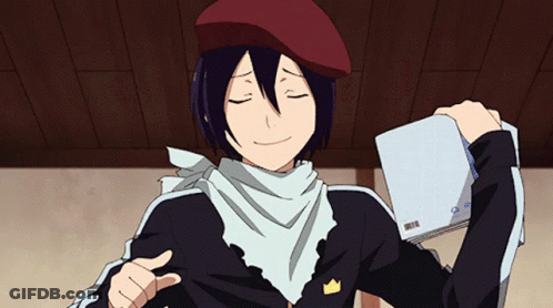A Man Wearing A Beret And Scarf Is Holding A Book And Giving A Thumbs Up Sign GIF