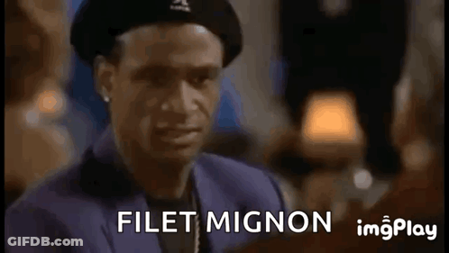 A Man Wearing A Beret Is Making A Funny Face And Says Filet Mignon GIF