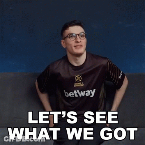 A Man Wearing A Betway Shirt Is Sitting On A Couch And Says Let 'S See What We Got . GIF