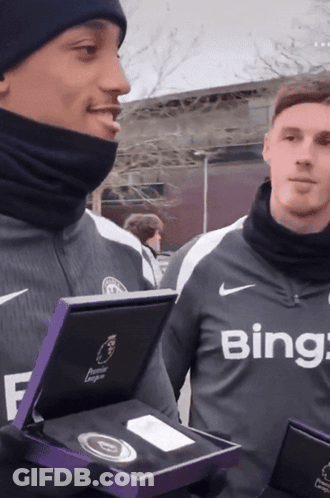 A Man Wearing A Bing Shirt Holds A Box GIF