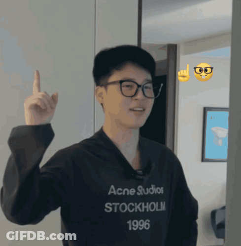 A Man Wearing A Black Acne Studios Stockholm 1996 Sweatshirt Points Up GIF
