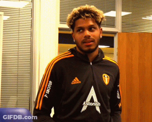 A Man Wearing A Black Adidas Jacket With The Word Astonish On The Front GIF