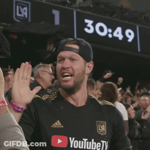 A Man Wearing A Black Adidas Shirt Giving A High Five GIF