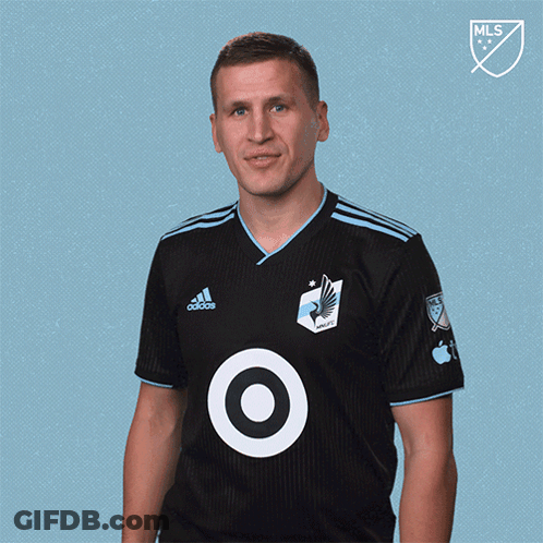 A Man Wearing A Black Adidas Shirt With A Target Logo On His Chest GIF