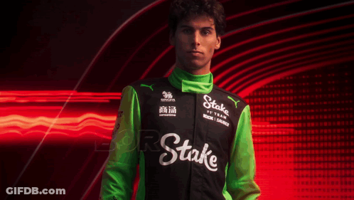 A Man Wearing A Black And Green Jacket With The Word Stake On The Front GIF