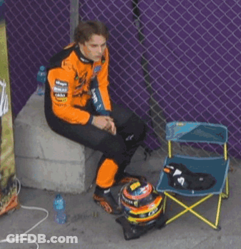 A Man Wearing A Black And Orange Jacket That Says Mastercard GIF