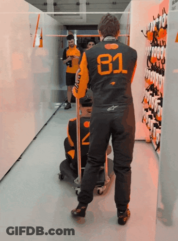 A Man Wearing A Black And Orange Jacket With The Number 81 On It GIF