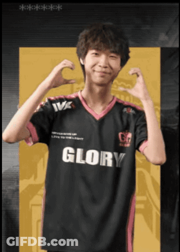 A Man Wearing A Black And Pink Glory Jersey Makes A Heart Shape With His Hands GIF