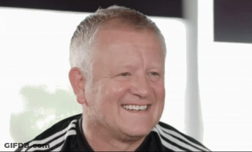 A Man Wearing A Black And White Adidas Shirt Smiles For The Camera GIF