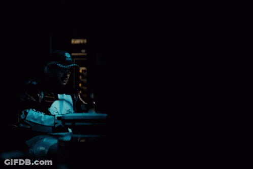 A Man Wearing A Black And White Jacket With The Word Ok On The Front GIF