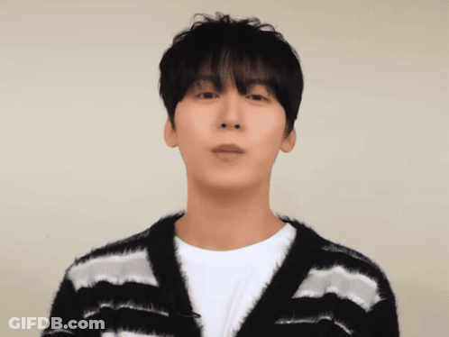 A Man Wearing A Black And White Striped Sweater Looks At The Camera GIF