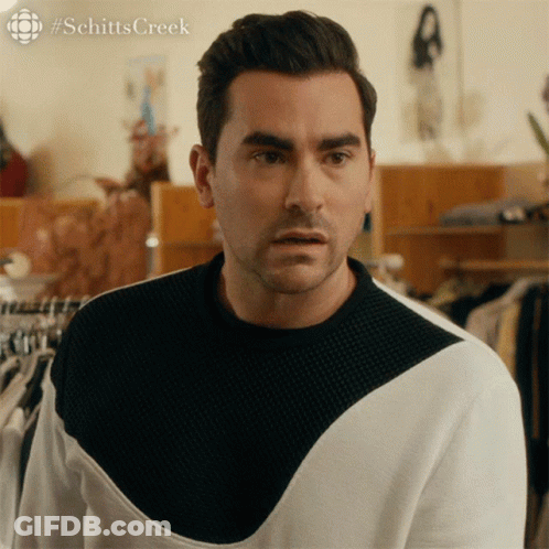 A Man Wearing A Black And White Sweater With #Schitts Creek Written On The Bottom GIF