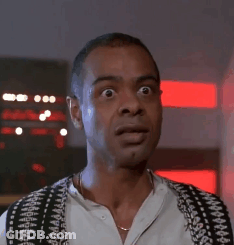 A Man Wearing A Black And White Vest Looks Surprised GIF