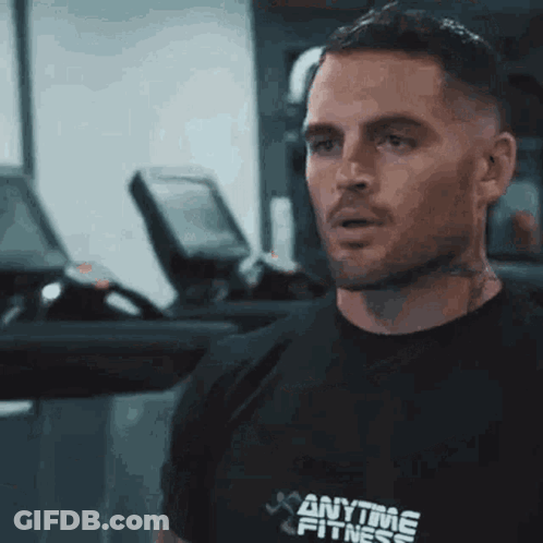 A Man Wearing A Black Anytime Fitness Shirt GIF