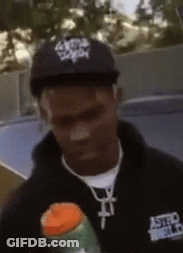 A Man Wearing A Black Astroworld Shirt Holds A Bottle GIF