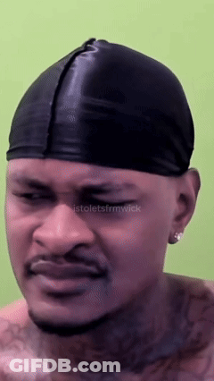 A Man Wearing A Black Beanie Has A Tattoo On His Chest GIF