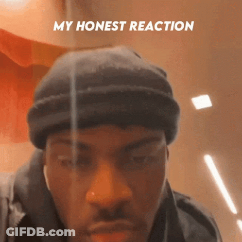 A Man Wearing A Black Beanie Has The Words My Honest Reaction Above His Face GIF