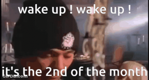 A Man Wearing A Black Beanie Says Wake Up ! Wake Up ! It 'S The 2Nd Of The Month . GIF