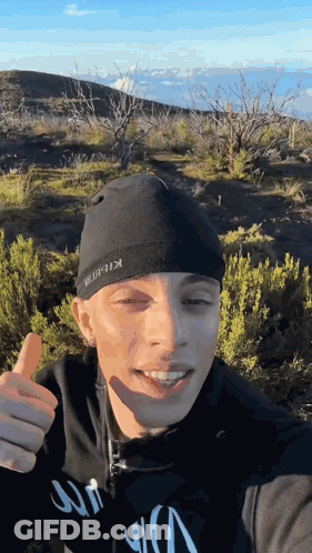 A Man Wearing A Black Beanie With The Word Kibbit On It GIF