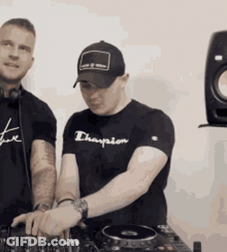 A Man Wearing A Black Champion Shirt Is Playing Music GIF