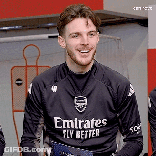 A Man Wearing A Black Emirates Fly Better Jersey Smiles GIF