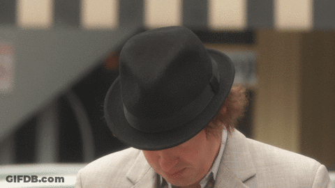 A Man Wearing A Black Fedora And A White Jacket GIF