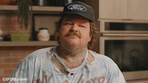 A Man Wearing A Black Ford Hat And A Dirty Shirt GIF